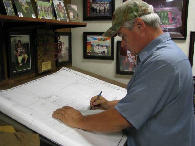 Reviewing electrical plans at the office desk